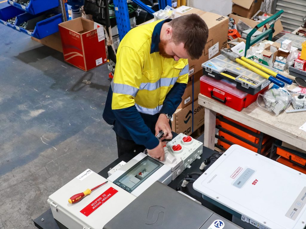 man working on an inverter
